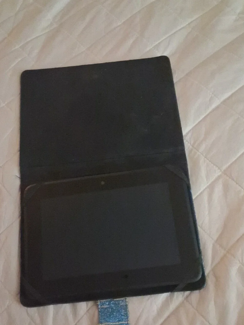 Amazon Kindle with blue case with stickers on